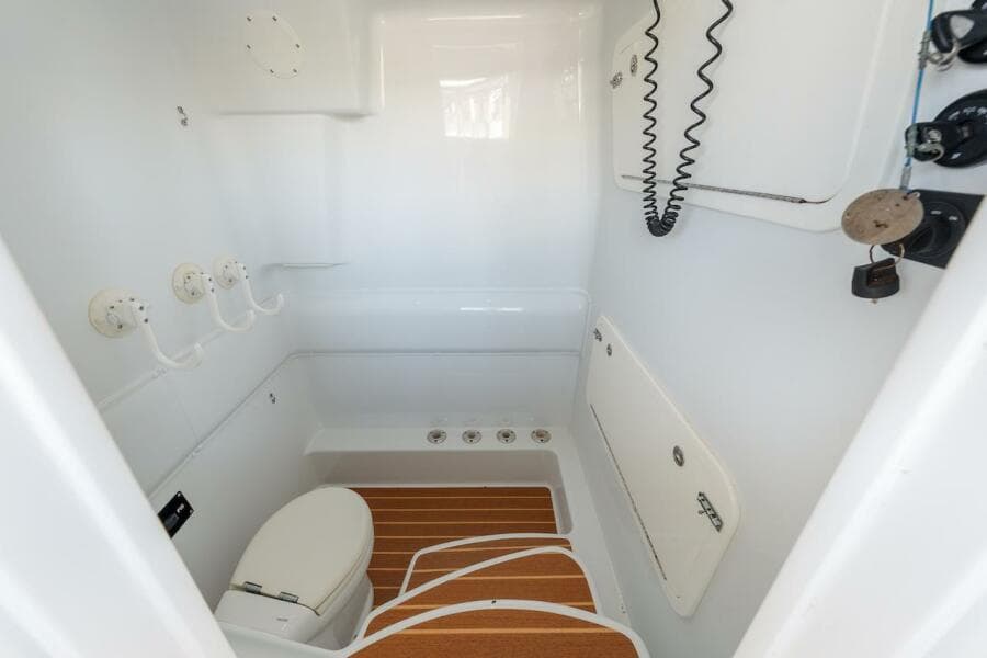 2015 Yellowfin 39 boat interior with toilet and wooden floor accents.