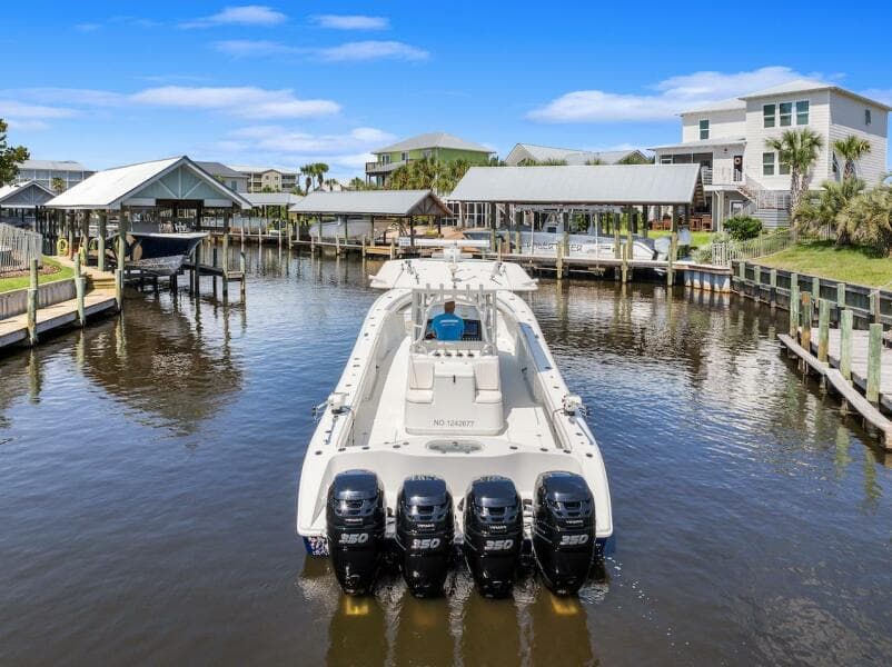 2015 Yellowfin 39 boat docked in a scenic waterfront area with multiple outboard engines.
