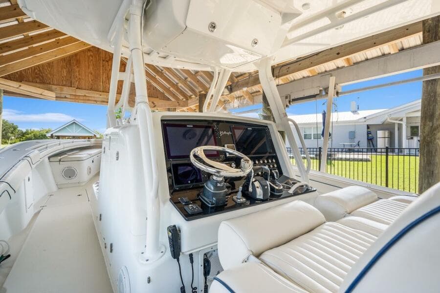2015 Yellowfin 39 boat interior with modern helm and seating under a wooden canopy.