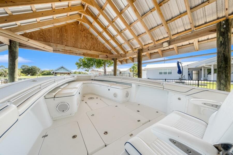 2015 Yellowfin 39 boat under wooden canopy, showcasing spacious seating and storage.