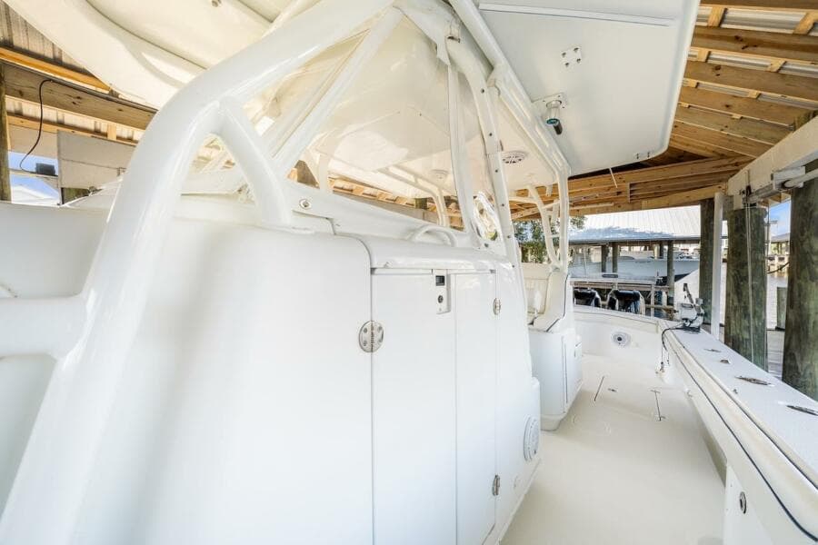 2015 Yellowfin 39 boat interior under covered dock, showcasing sleek white design.