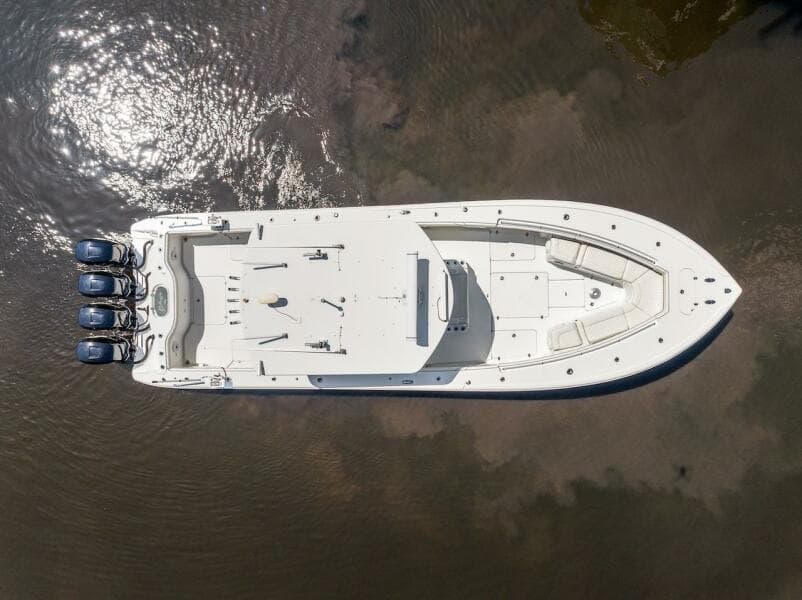 Aerial view of 2015 Yellowfin 39 boat with triple engines on calm water.