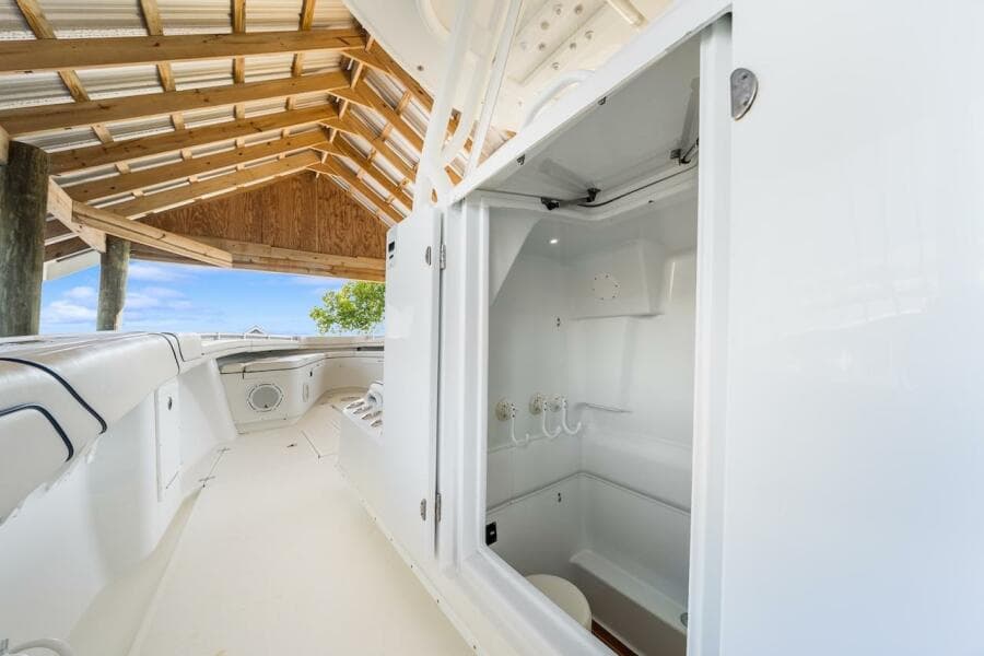 2015 Yellowfin 39 boat interior with open storage compartment under a wooden canopy.