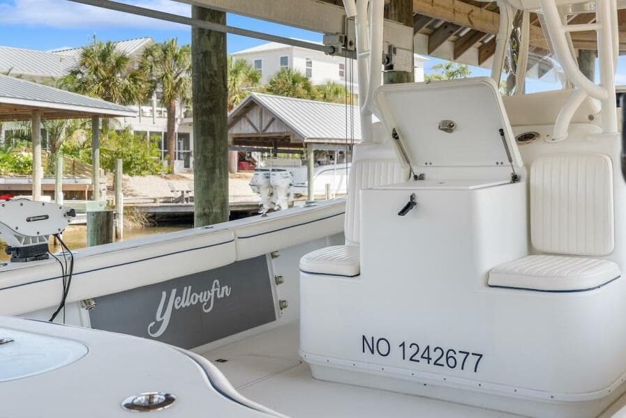 2015 Yellowfin 39 boat interior with seating and storage, docked at a marina.