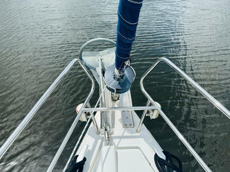 Bow view of 2015 Beneteau Oceanis 45 sailboat with anchor and railing.