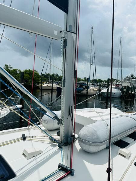 2015 Beneteau Oceanis 45 sailboat docked, featuring mast and rigging, with cloudy sky backdrop.