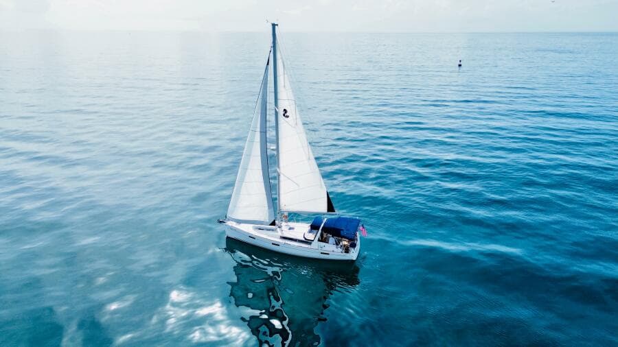 Sailing yacht Beneteau Oceanis 45, 2015 model, gliding on calm blue waters.