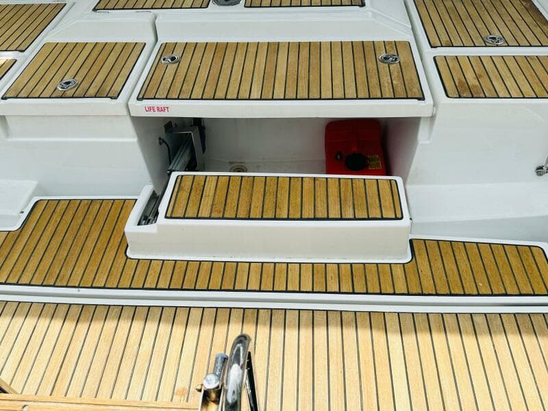 Teak deck of 2015 Beneteau Oceanis 45 sailboat with life raft compartment.