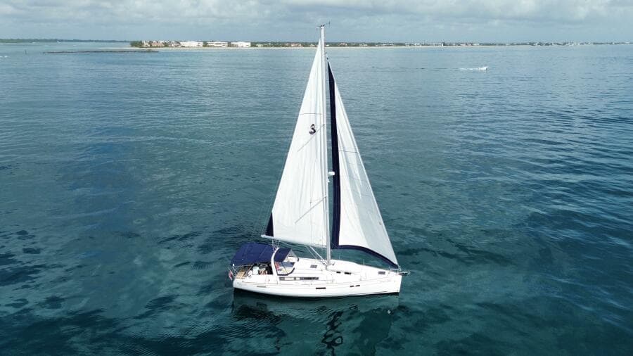 Sailing yacht Beneteau Oceanis 45, 2015 model, cruising on calm blue waters.