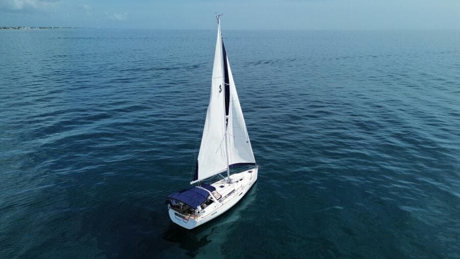 Sailing yacht Beneteau Oceanis 45, 2015 model, cruising on calm blue waters.