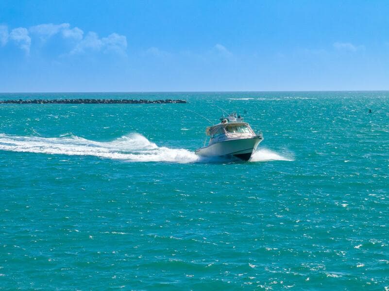 2007 Grady-White Express 360 boat cruising on turquoise ocean waters.