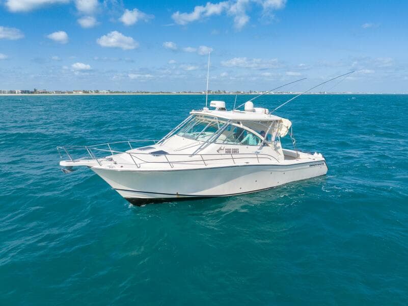 2007 Grady-White Express 360 boat on open sea under clear blue sky.