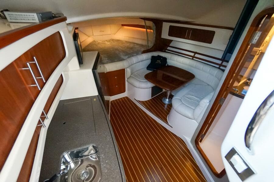 2007 Grady-White Express 360 interior with wood flooring and cozy seating area.