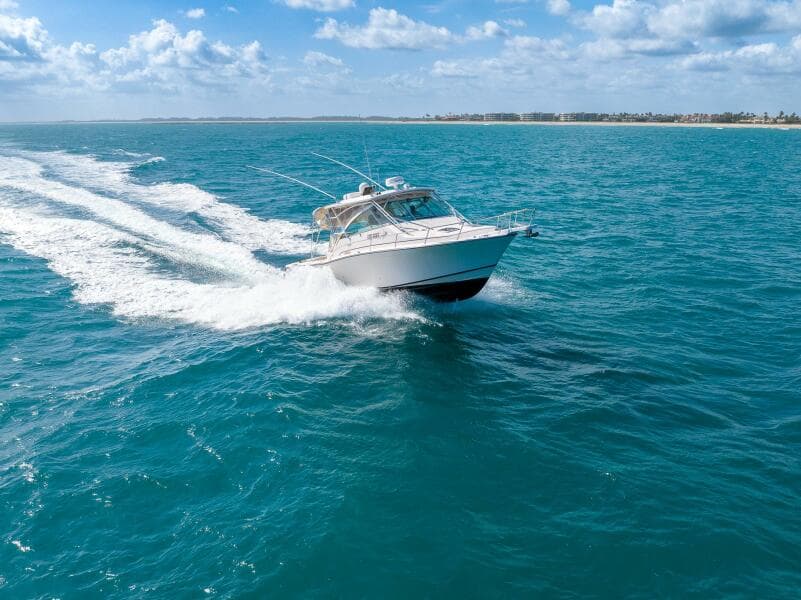 2007 Grady-White Express 360 cruising on clear blue ocean under a sunny sky.