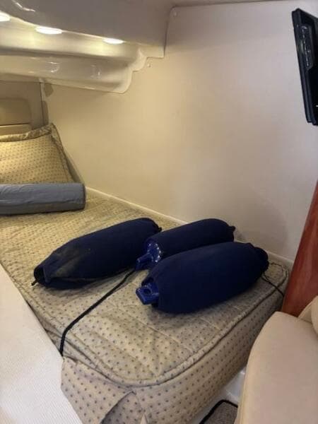 Interior cabin of 2007 Monterey 350 Sport Yacht with cushions and fenders.