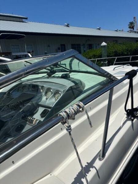 2007 Monterey 350 Sport Yacht with sleek dashboard and mooring rope, docked under clear blue sky.
