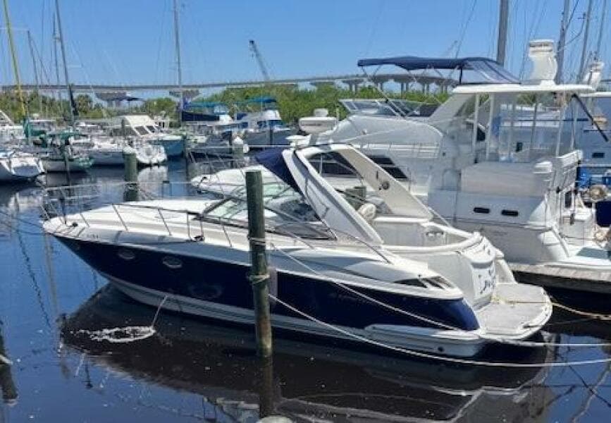 2007 Monterey 350 Sport Yacht docked at a marina, surrounded by other boats.