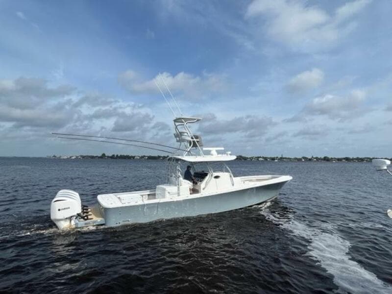 2018 Regulator 41 boat cruising on open water under a cloudy sky.