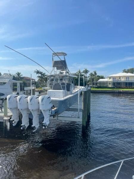 2018 Regulator 41 boat docked with four outboard engines, under a clear blue sky.