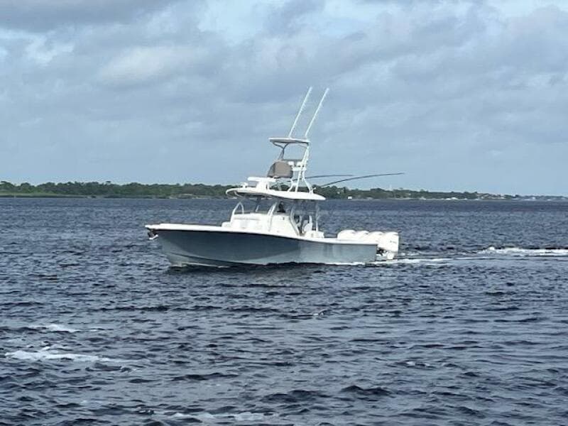 2018 Regulator 41 boat cruising on open water under cloudy skies.