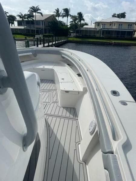 2018 Regulator 41 boat deck with seating, docked near waterfront homes.