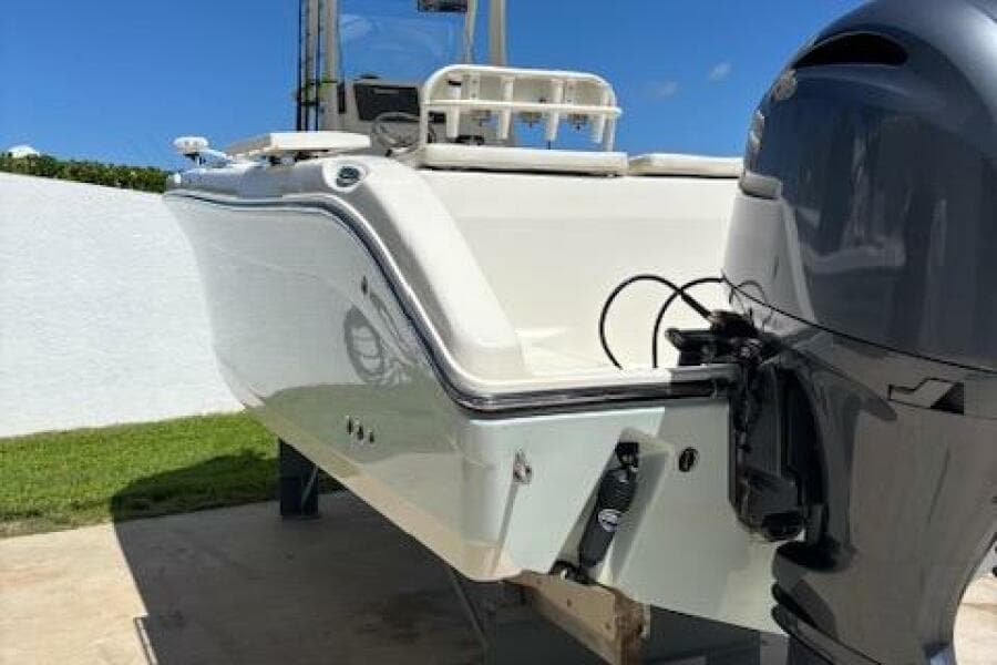 2018 Century 2600 Center Console boat with outboard motor, docked outdoors.