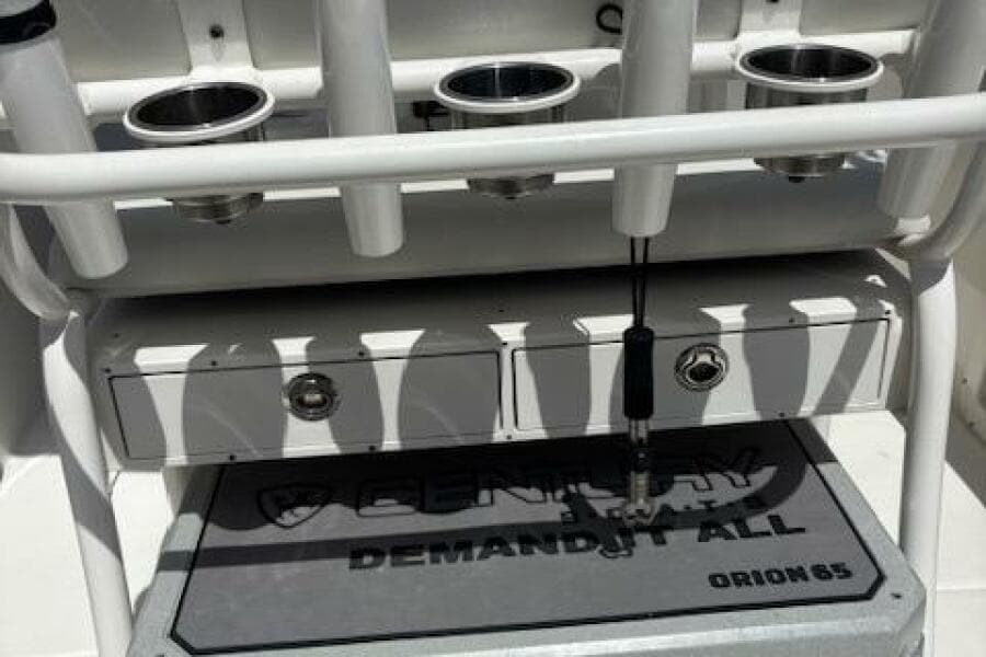 2018 Century 2600 Center Console boat with rod holders and storage compartments.