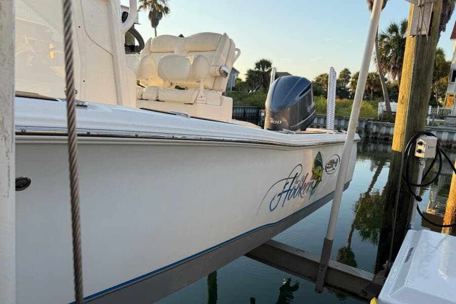 2018 Sea Hunt BX 25 FS boat docked, featuring a powerful outboard motor.