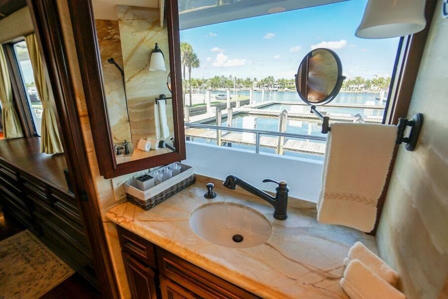 Luxurious bathroom in 1996 ABD 90 Explorer yacht with marina view.