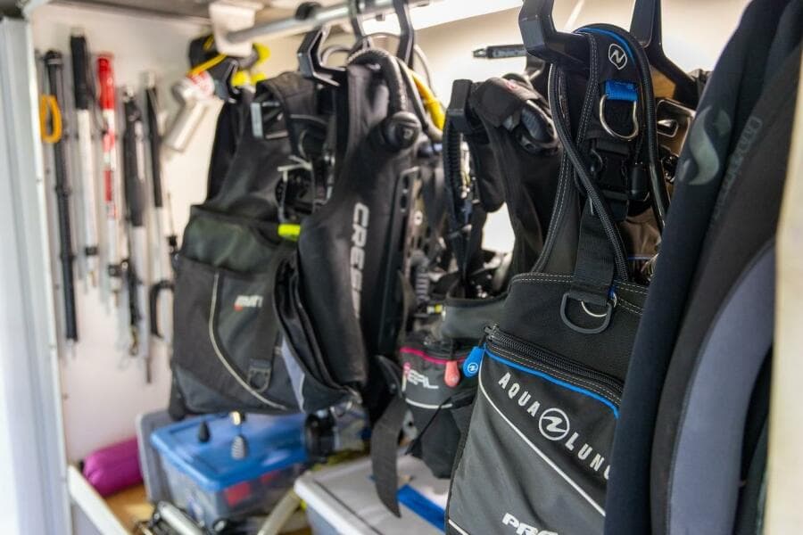 Diving gear storage with wetsuits and equipment in a well-organized space.