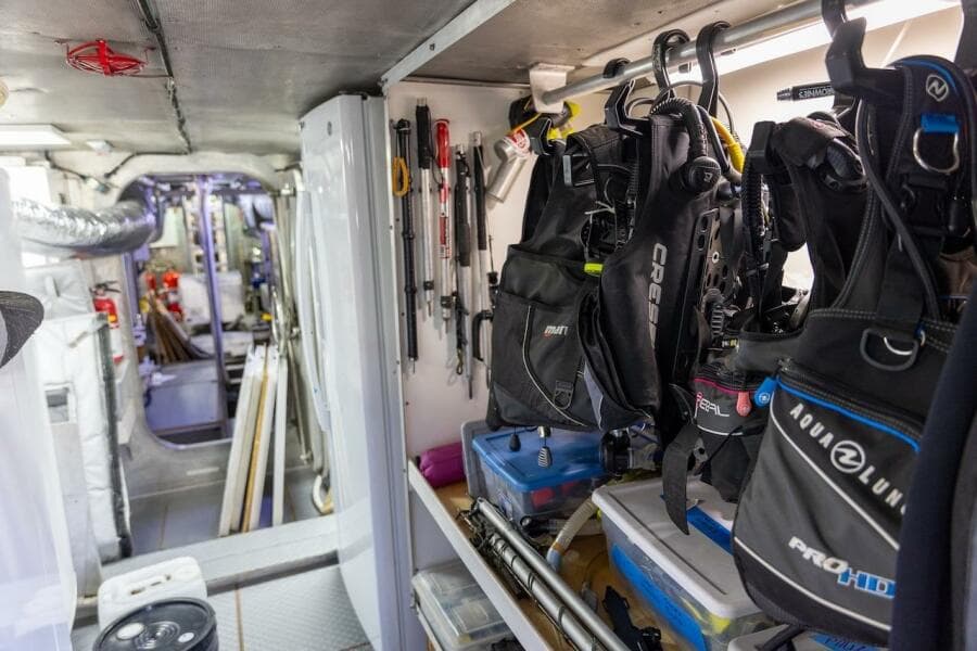 Diving equipment storage inside 1996 ABD 90 Explorer yacht, featuring organized gear and tools.