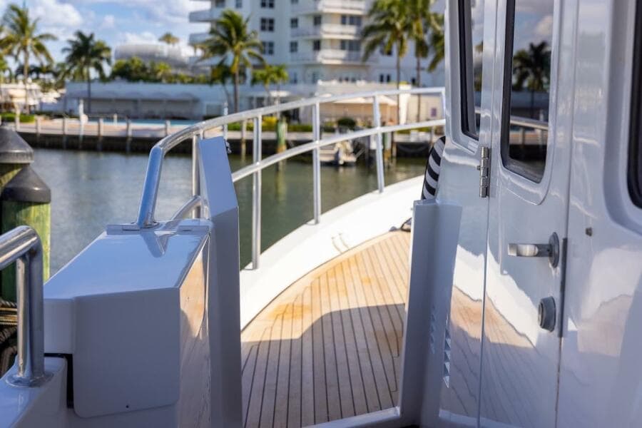 Deck view of 1996 ABD 90 Explorer yacht with wooden flooring and railing.