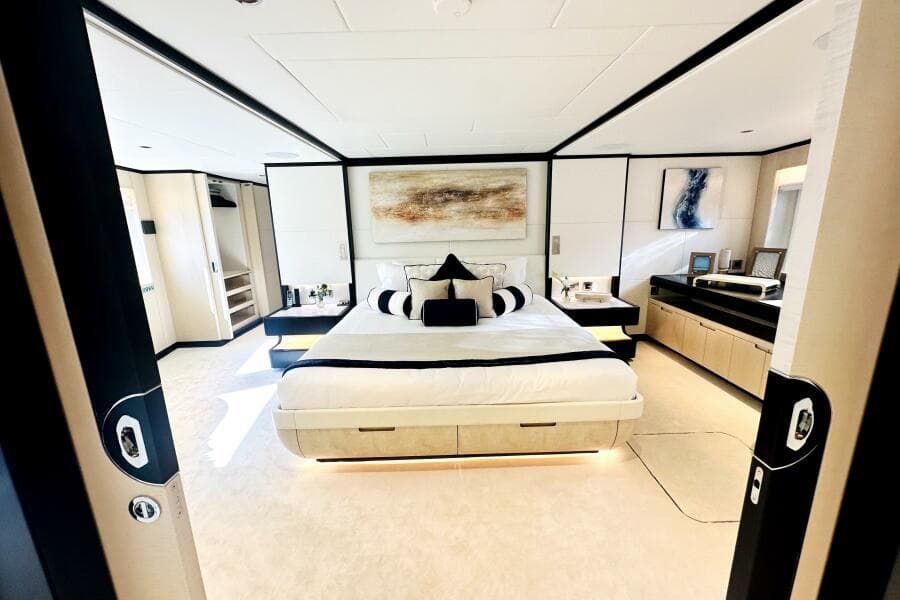 Luxurious 2023 Majesty 120 yacht bedroom with modern decor and elegant furnishings.