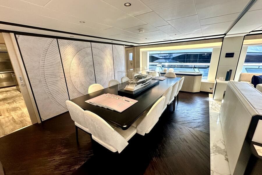 Luxurious interior of 2023 Majesty 120 yacht with elegant dining area and modern decor.