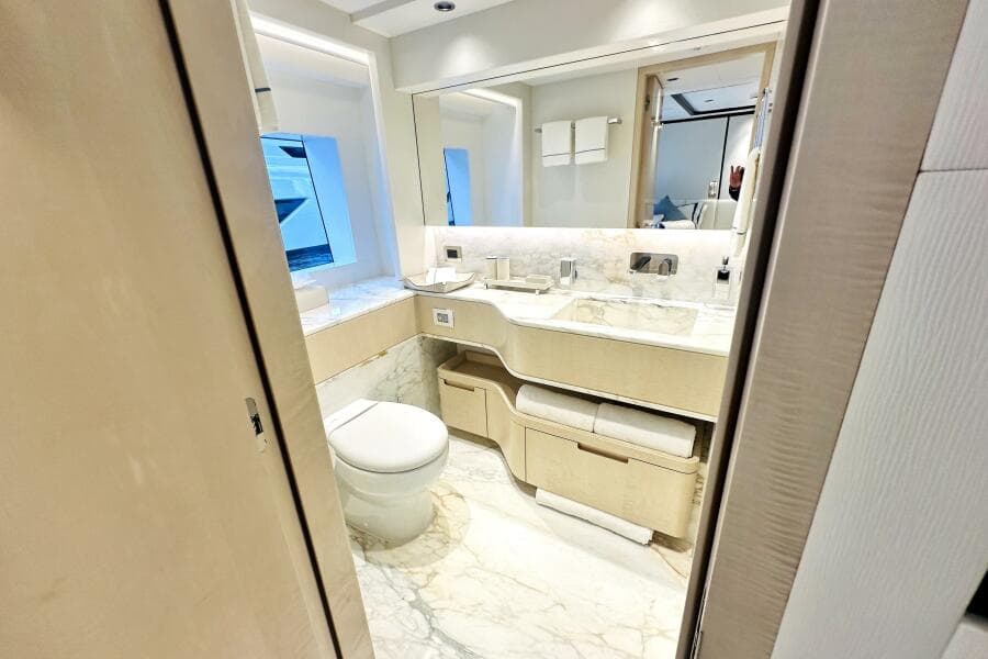 Luxurious bathroom in 2023 Majesty 120 yacht with marble accents and modern fixtures.