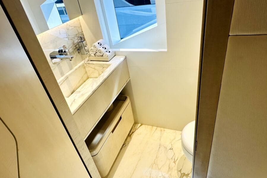 Luxurious bathroom in 2023 Majesty 120 yacht with marble sink and modern fixtures.