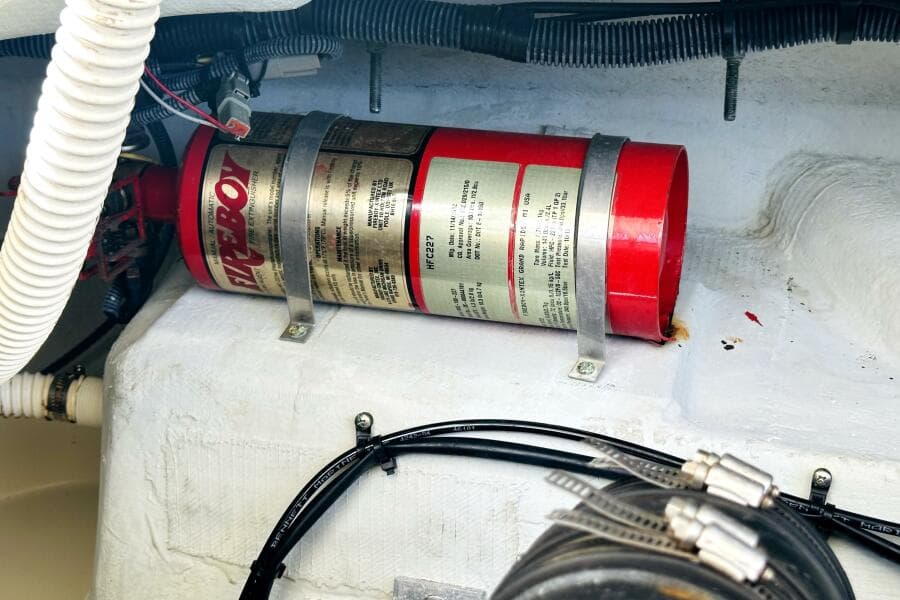 Engine compartment of 2013 Chris-Craft Corsair 22 with mounted fire extinguisher.