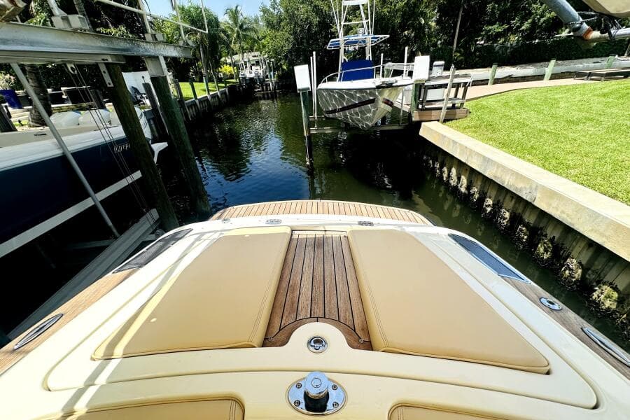 2013 Chris-Craft Corsair 22 docked in a serene canal setting.