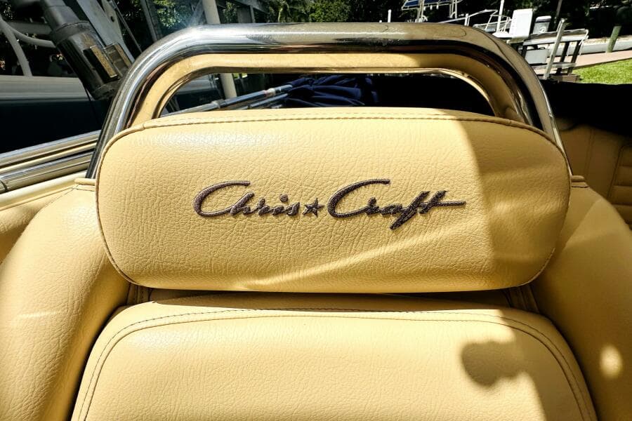 2013 Chris-Craft Corsair 22 boat seat with logo, featuring beige leather upholstery.