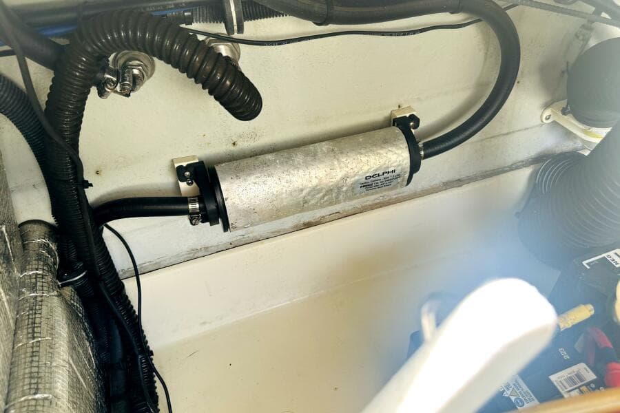 Engine compartment of 2013 Chris-Craft Corsair 22 with visible hoses and components.