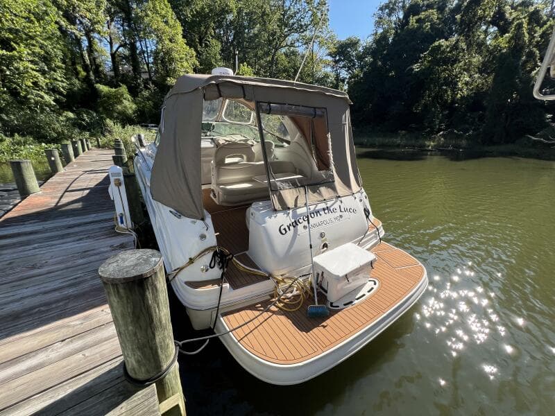 2002 Sea Ray 360 Sundancer docked, featuring a Camper Cover and Faux Teak SeaDek on the Swim Platform