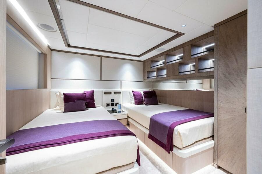 Luxurious twin bedroom on 2020 Majesty 140 yacht with modern decor and purple accents.