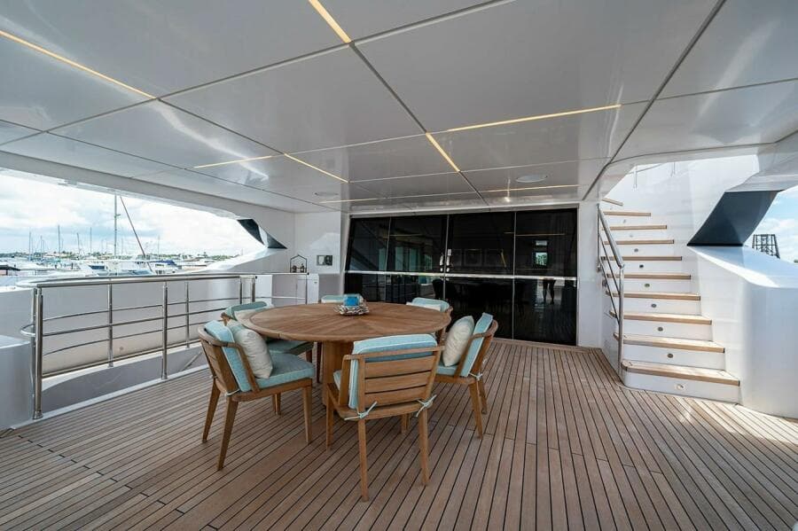 Spacious deck of 2020 Majesty 140 yacht with wooden furniture and modern design.