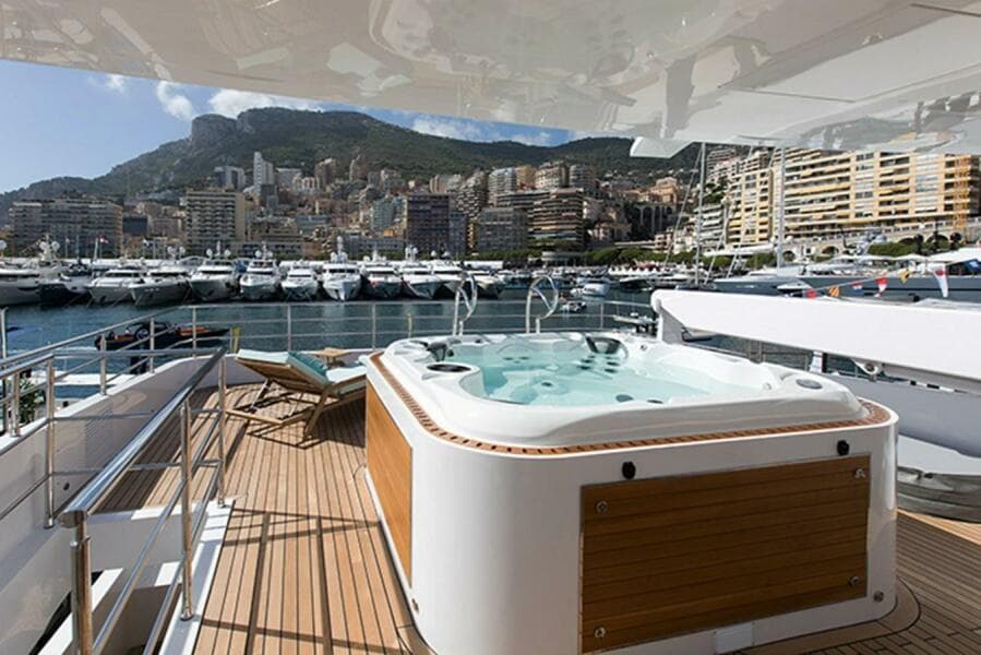 Luxury yacht Majesty 140 with jacuzzi, docked in a scenic marina, 2020 model.