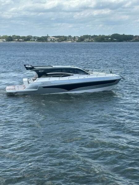 2025 Real 40 HT Luxury yacht cruising on a calm sea under a cloudy sky.