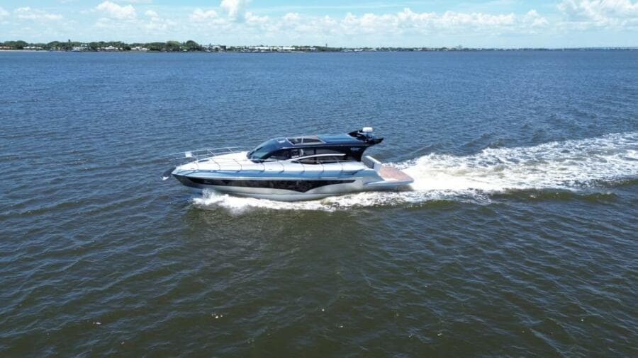 2025 Real 40 HT Luxury yacht cruising on open water under a clear sky.
