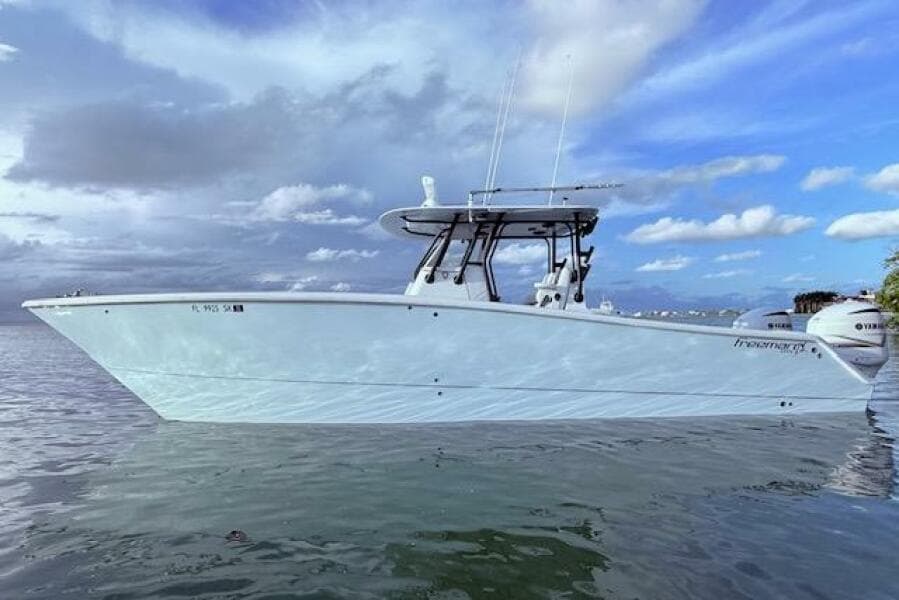 2019 Freeman 34 boat on calm water under a partly cloudy sky.