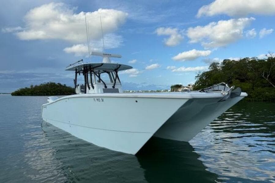 2019 Freeman 34 boat on calm water under a partly cloudy sky.