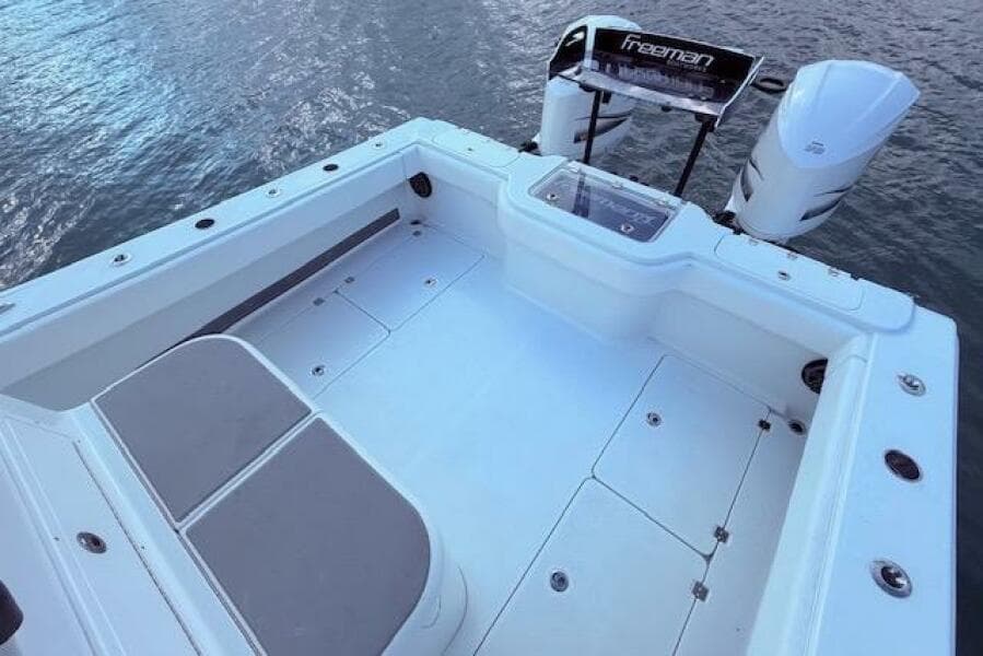 2019 Freeman 34 boat deck with dual engines on calm water.