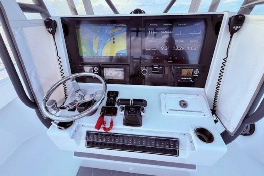 Cockpit of 2019 Freeman 34 boat with navigation screens and controls.